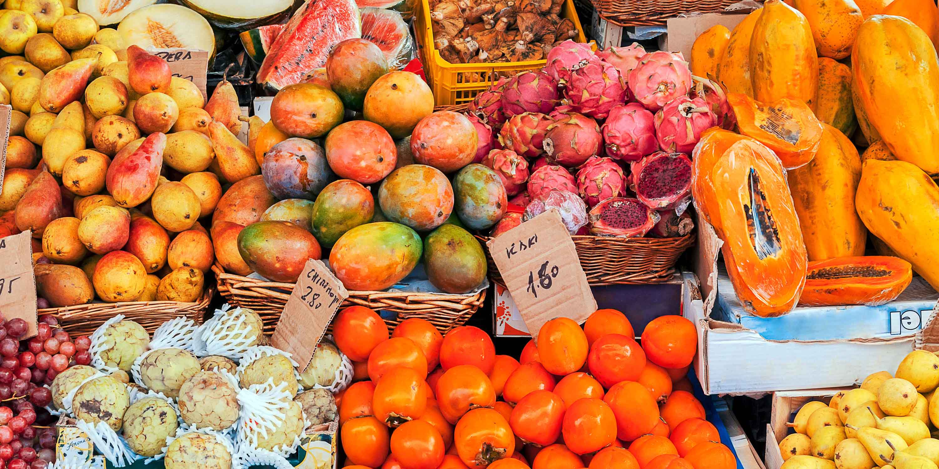 vibrant coloured fruits on a table at a market stall